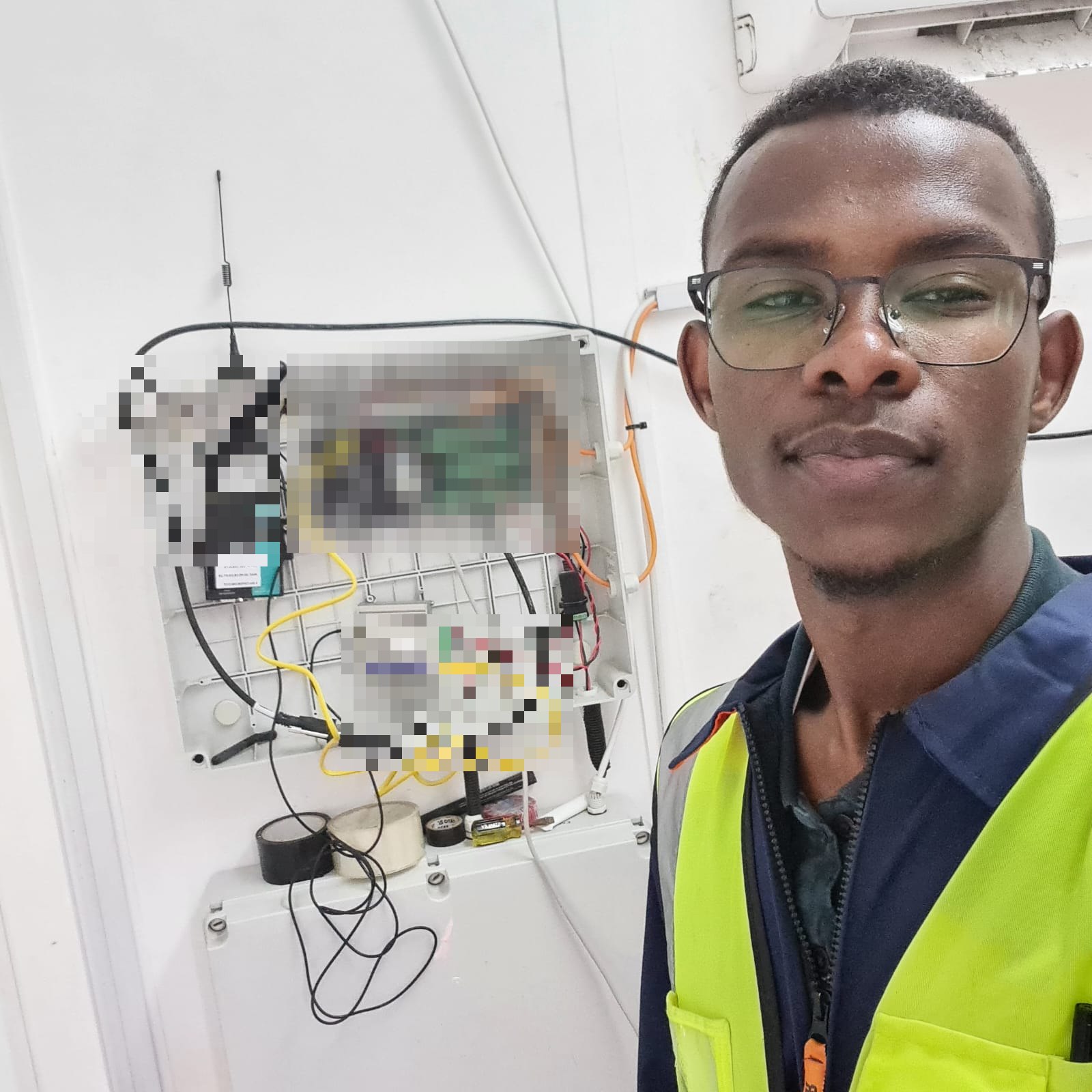 Husam beside the open onshore source-station enclosure