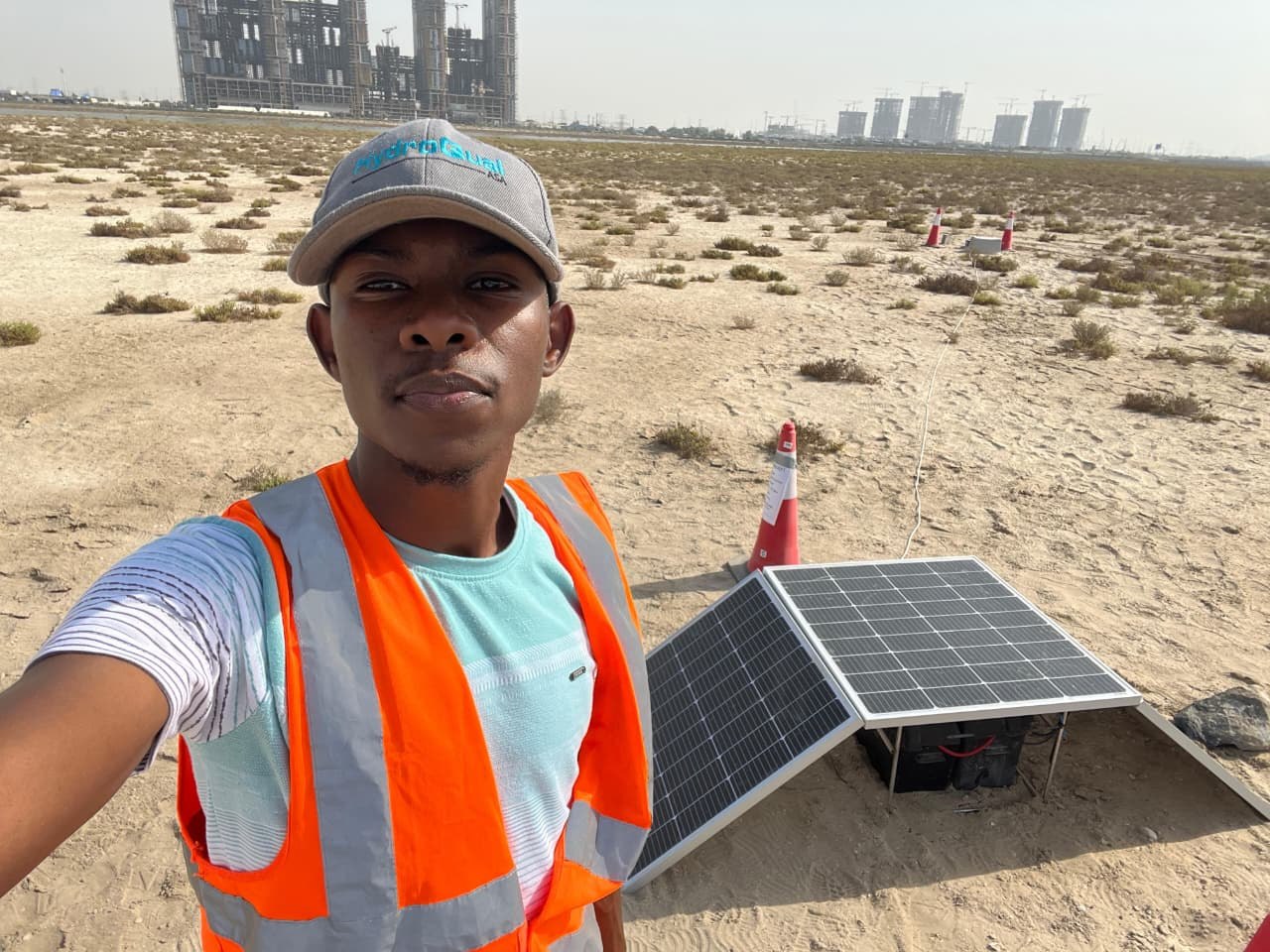 Husam beside the solar-powered monitoring installation at Ras Al Khor